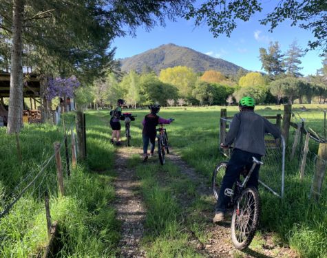 Image Of Cyclists On Baton River Property With Mountain In The Background